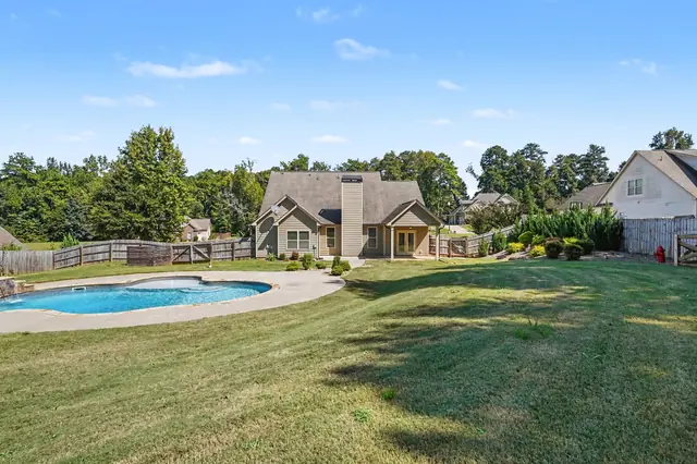 Community pool beyond a wide lawn